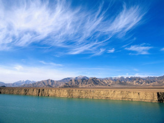 Lake mountains blue sky clouds 3 - a few boat free wallpaper