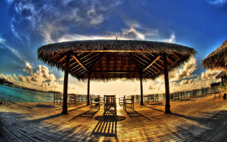 Wooden pier thatched roof sunset - a wooden pier free wallpaper