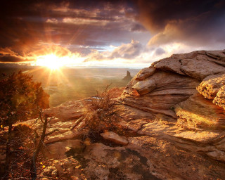 Sunset rocky cliff tree clouds 3 - a sunset over a rocky cliff free wallpaper