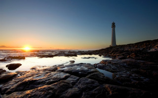 Lighthouse rocky shore sunset sun 2 - the background and the water free wallpaper