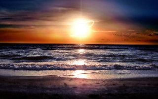 Sunset ocean wave shore sky 3 - a bright sun in the sky above free wallpaper