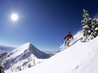 Skier skiing snowy mountain slope 3 - a skier free wallpaper