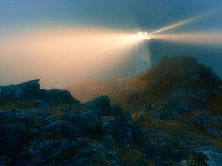 Lighthouse rocky cliff light beam - radiant free wallpaper
