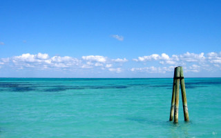 Wooden pole ocean sky clouds 2 - the ocean water free wallpaper