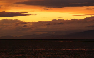 Sunset boat mountains clouds water - a few light free wallpaper