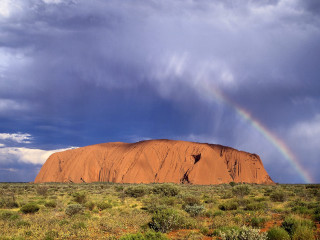 Rainbow desert rock sky ground 5 - a rainbow in the sky above free wallpaper