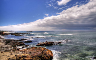 Rocky beach water cloudy sky 5 - a rocky shore line free wallpaper