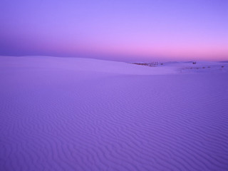 Purple sky sand dunes distant - a building in the distance free wallpaper