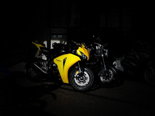 Yellow motorcycle parked dark black - a yellow motorcycle free wallpaper