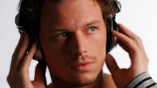 Man headphones serious look camera - his ear free wallpaper