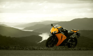 Motorcycle parked mountain range lake - a lake in the background free wallpaper
