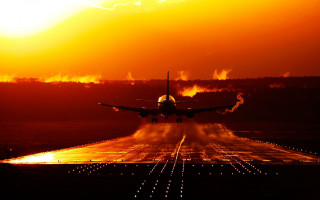 Plane takeoff sunset backlit cityscape - an airport runway free wallpaper